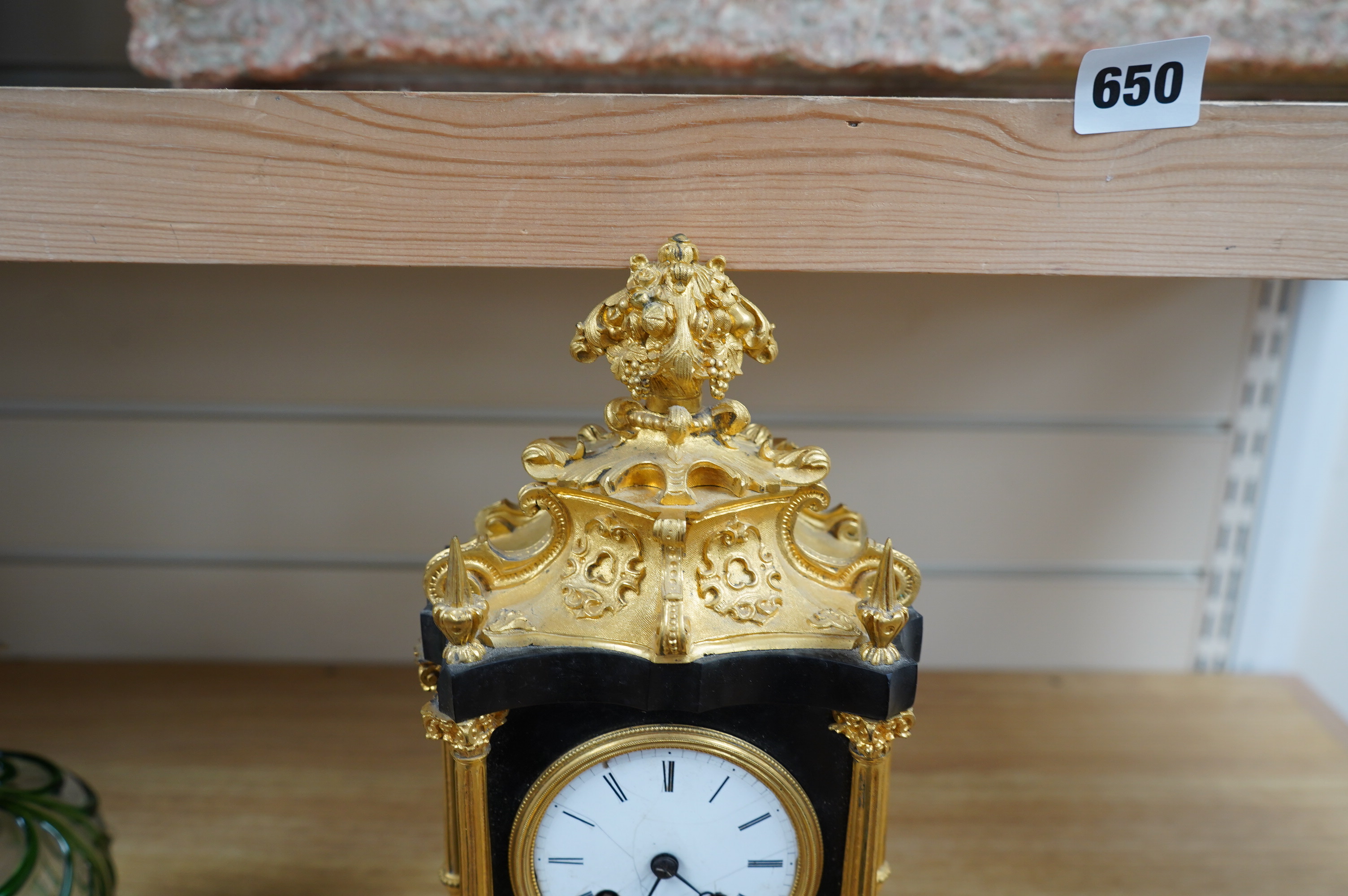 A French ormolu and slate mantle clock with a silk suspension movement, 33cm high. Condition - fair, cracks to the enamel dial.